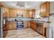Bright kitchen featuring stainless steel appliances, wood cabinets, and hard surface countertops at 7245 Prairie Cir, Longmont, CO 80504