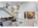 Inviting living room featuring staircase, comfortable seating, and open floor plan to dining and kitchen at 7245 Prairie Cir, Longmont, CO 80504