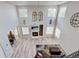 Bright open living room with high ceilings, fireplace, large windows and modern decor at 7245 Prairie Cir, Longmont, CO 80504