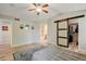 Main bedroom features an ensuite bath and a large closet with a decorative sliding barn door at 7245 Prairie Cir, Longmont, CO 80504