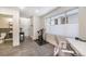 Finished basement area with an exercise bike, desk, and a view into a nearby bathroom at 5610 S Sycamore St, Littleton, CO 80120
