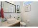 Clean half bathroom showcasing a modern vessel sink, decorative mirror, and tiled backsplash for a stylish look at 5610 S Sycamore St, Littleton, CO 80120
