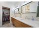 Modern bathroom featuring dual sinks, granite countertops, and a walk-in closet, providing comfort and style at 5610 S Sycamore St, Littleton, CO 80120