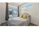 Cozy bedroom with large windows, neutral décor, and a comfortable bed with colorful pillows at 5610 S Sycamore St, Littleton, CO 80120