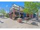 Attractive brick building with outdoor seating area and awnings, perfect for a restaurant or retail space at 5610 S Sycamore St, Littleton, CO 80120