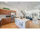 Bright kitchen featuring an island with seating, wooden cabinets, stainless steel appliances, and hardwood floors at 5610 S Sycamore St, Littleton, CO 80120