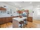Spacious kitchen features wood cabinets, stainless steel appliances, and a center island with a white countertop at 5610 S Sycamore St, Littleton, CO 80120