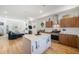 A modern kitchen with a center island, stainless steel appliances, and hardwood floors, offering a comfortable space for cooking at 5610 S Sycamore St, Littleton, CO 80120