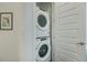 The laundry room features stacked washer and dryer units next to a white door at 5610 S Sycamore St, Littleton, CO 80120