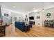 Spacious living room with hardwood floors, a comfortable blue sofa, and plenty of natural light at 5610 S Sycamore St, Littleton, CO 80120
