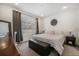 Comfortable main bedroom with neutral tones, a large window, and a padded storage ottoman at 5610 S Sycamore St, Littleton, CO 80120