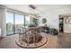 Bright dining area boasts city views, table for six, and stylish modern lighting at 1020 15Th St # 42C, Denver, CO 80202