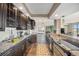 Beautiful open kitchen featuring stainless appliances, dark wood cabinetry, and breakfast bar at 1020 15Th St # 42C, Denver, CO 80202