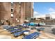 Sun-drenched pool deck with multiple lounge chairs at 1020 15Th St # 42C, Denver, CO 80202