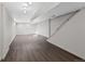 Large basement featuring clean white walls, overhead lights, and durable wood-look floors at 141 S Fraser Cir, Aurora, CO 80012