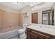 Bathroom showcasing a bathtub, toilet, and single sink vanity with neutral-toned features at 141 S Fraser Cir, Aurora, CO 80012