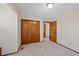 Bedroom with carpet, closet, and doorway showcasing neutral-toned wall colors at 141 S Fraser Cir, Aurora, CO 80012