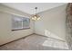 Cozy dining area with chandelier lighting and large window at 141 S Fraser Cir, Aurora, CO 80012