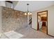 Inviting dining area features stone wall accent and is adjacent to the updated kitchen at 141 S Fraser Cir, Aurora, CO 80012