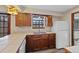 Kitchen featuring wood cabinets, white appliances, and tile countertops at 141 S Fraser Cir, Aurora, CO 80012