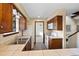 Well-lit kitchen with wood cabinets, white appliances, and tile countertops at 141 S Fraser Cir, Aurora, CO 80012