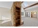 Bright living room with stone fireplace, skylight and built-in bookcase at 141 S Fraser Cir, Aurora, CO 80012