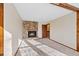 Living room featuring a stone fireplace, carpet, and natural light from a window at 141 S Fraser Cir, Aurora, CO 80012