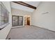 Bright living room features beamed vaulted ceiling and new carpet at 141 S Fraser Cir, Aurora, CO 80012