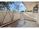 Enclosed outdoor patio with a gate, concrete pad, and view of surrounding landscape at 141 S Fraser Cir, Aurora, CO 80012