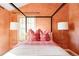 Bedroom with four-poster bed and coral walls at 626 Fillmore St, Denver, CO 80206