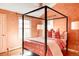 Bedroom with a four-poster bed and coral walls at 626 Fillmore St, Denver, CO 80206