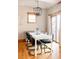 Sunlit dining area with a white table and black chairs at 626 Fillmore St, Denver, CO 80206