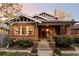 Brick home with inviting front porch and well-manicured landscaping at 626 Fillmore St, Denver, CO 80206