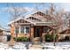 Brick home with craftsman style details and snowy front yard at 626 Fillmore St, Denver, CO 80206