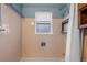 Bathroom with a shower-tub combo and window allowing for great light at 8701 Majestic View Dr, Conifer, CO 80433