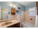 Well-lit bathroom featuring a vanity with a marble top, a tub with shower, and ample storage at 8701 Majestic View Dr, Conifer, CO 80433