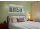 Cozy bedroom with a view and a large window, providing natural light and an inviting atmosphere at 8701 Majestic View Dr, Conifer, CO 80433