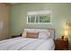 Comfortable bedroom features a plush queen-sized bed, neutral decor, and a serene window view for a peaceful retreat at 8701 Majestic View Dr, Conifer, CO 80433