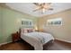 Bright and airy bedroom with two windows, queen-sized bed, and minimalist decor for a cozy and relaxing atmosphere at 8701 Majestic View Dr, Conifer, CO 80433