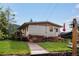 Charming single-story home with wooden deck, brick accents, and manicured lawn at 8701 Majestic View Dr, Conifer, CO 80433