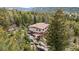 Scenic mountain home featuring a private deck and surrounded by lush forest and natural rock formations at 8701 Majestic View Dr, Conifer, CO 80433