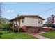 Charming single-story home with wooden deck, brick accents, and manicured lawn at 8701 Majestic View Dr, Conifer, CO 80433