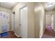 Hallway with doors and textured walls, creating a neutral and functional space at 8701 Majestic View Dr, Conifer, CO 80433