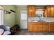Cozy kitchen featuring ample counter space, wooden cabinets, direct access to the back door, and built-in bench with storage at 8701 Majestic View Dr, Conifer, CO 80433