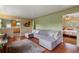 Spacious living room with beautiful hardwood floors and a large comfortable sofa, seamlessly connecting to the kitchen and bedroom at 8701 Majestic View Dr, Conifer, CO 80433