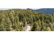 A winding road through lush forest leads to the property offering privacy and seclusion at 8701 Majestic View Dr, Conifer, CO 80433