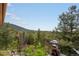 The backyard features a mature forest and rock formations at 8701 Majestic View Dr, Conifer, CO 80433