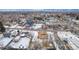 Aerial view of a house with a yard, detached garage, and nearby businesses at 3780 Benton St, Wheat Ridge, CO 80212