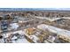 House and surrounding area shown in this snowy aerial view at 3780 Benton St, Wheat Ridge, CO 80212