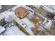 Aerial view of a house, detached garage and snow-covered yard at 3780 Benton St, Wheat Ridge, CO 80212